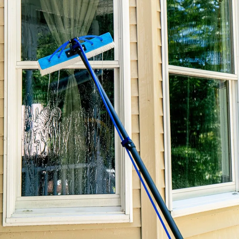 Water-fed pole brush rinsing exterior window glass